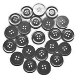 Several black and gray Commercial Food Service Buttons with four holes are arranged in a spiral pattern on a white background.