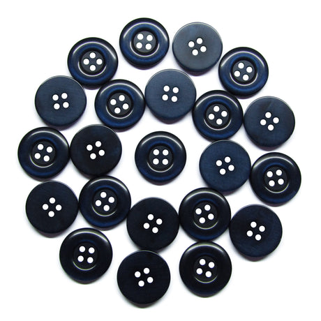 Twenty-three Commercial Food Service Buttons made of black nylon, each with four holes, are scattered in a circular pattern on a white background.