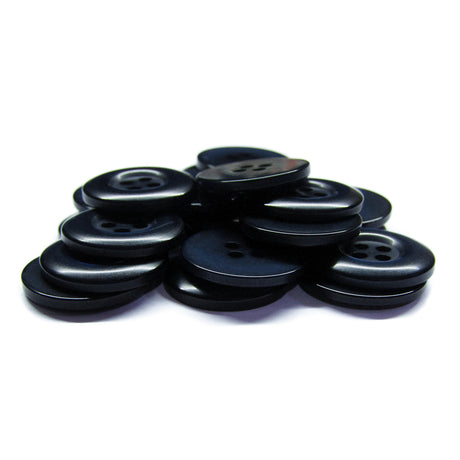 A pile of Commercial Food Service Buttons in black nylon stacked on a white background, ideal for use as plain uniform or work uniform buttons.