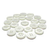 A scattered group of small, round, white Commercial Food Service Buttons with four holes is displayed on a white background.