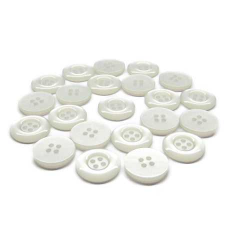 A scattered group of small, round, white Commercial Food Service Buttons with four holes is displayed on a white background.