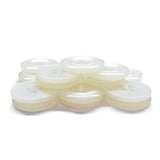 A stack of Commercial Food Service Buttons—translucent white, four-hole plastic—on a white surface, ideal for use as plain or work uniform buttons.
