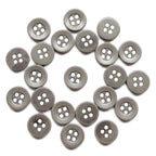 Twenty gray Workshop Uniform Shirt Buttons, made of durable four-hole nylon, are arranged in a roughly circular pattern on a white background.