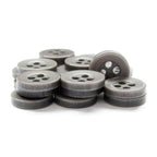 A stack of dark gray, round Workshop Uniform Shirt Buttons made of durable nylon with four holes arranged on a white background.