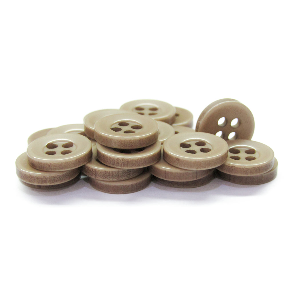 A stack of Workshop Uniform Shirt Buttons—light brown, four-hole, durable nylon—displayed on a white background.