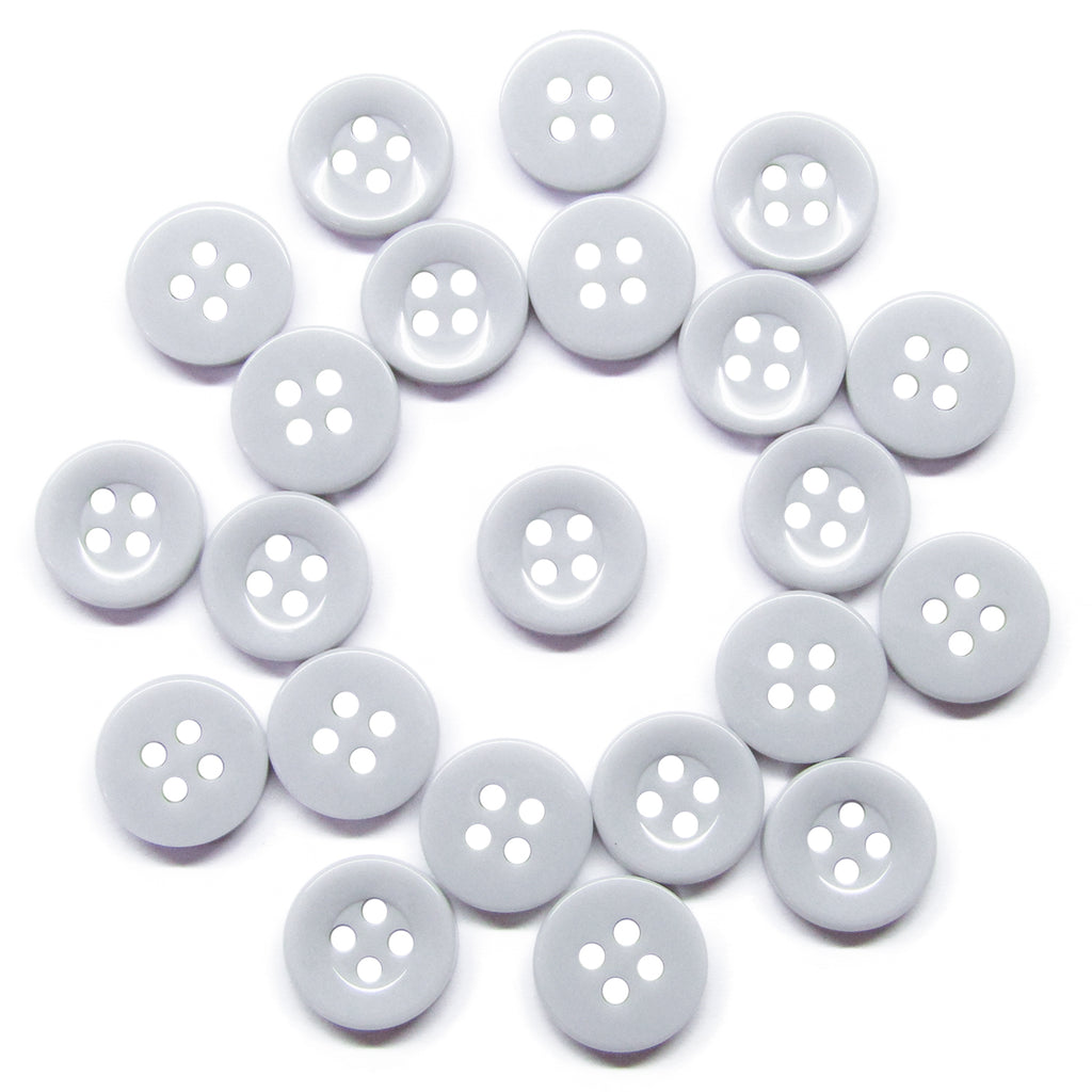 Twenty white nylon Workshop Uniform Shirt Buttons, each with four holes, are arranged in a loose circle on a white background—perfect for use on workshop uniform shirts.