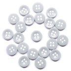Twenty white nylon Workshop Uniform Shirt Buttons, each with four holes, are arranged in a loose circle on a white background—perfect for use on workshop uniform shirts.