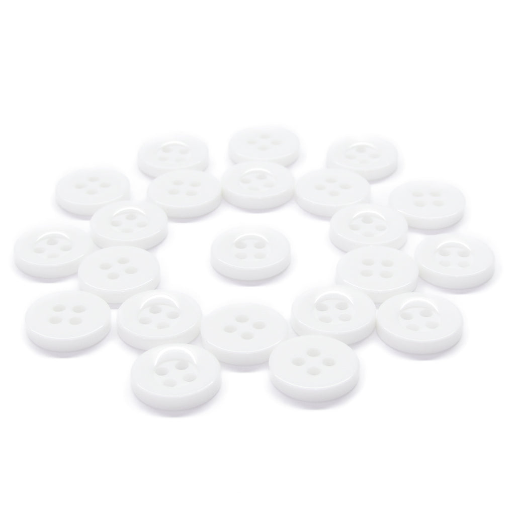Scattered white, round, four-hole Workshop Uniform Shirt Buttons—durable nylon fasteners—are arranged on a plain white background.
