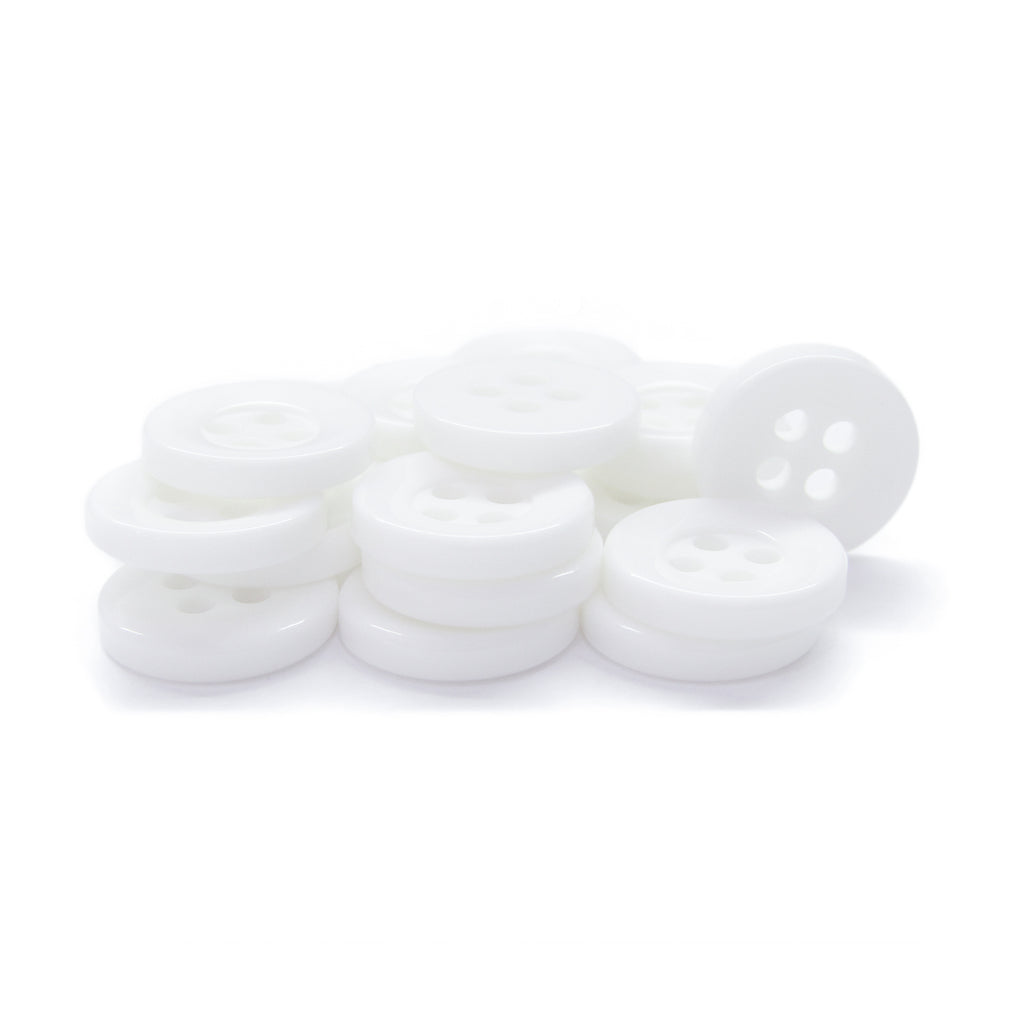 A collection of Workshop Uniform Shirt Buttons—small, round, durable nylon buttons with four holes each—is displayed on a white background.
