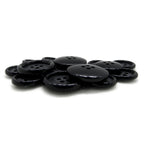 A pile of Luxury Suit Buttons, black, round, four-hole buffalo bone buttons displayed on a white background.