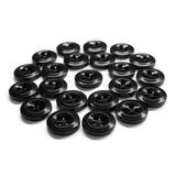 Twenty black Work Shirt Buttons with four holes, arranged in a loose group on a white background.