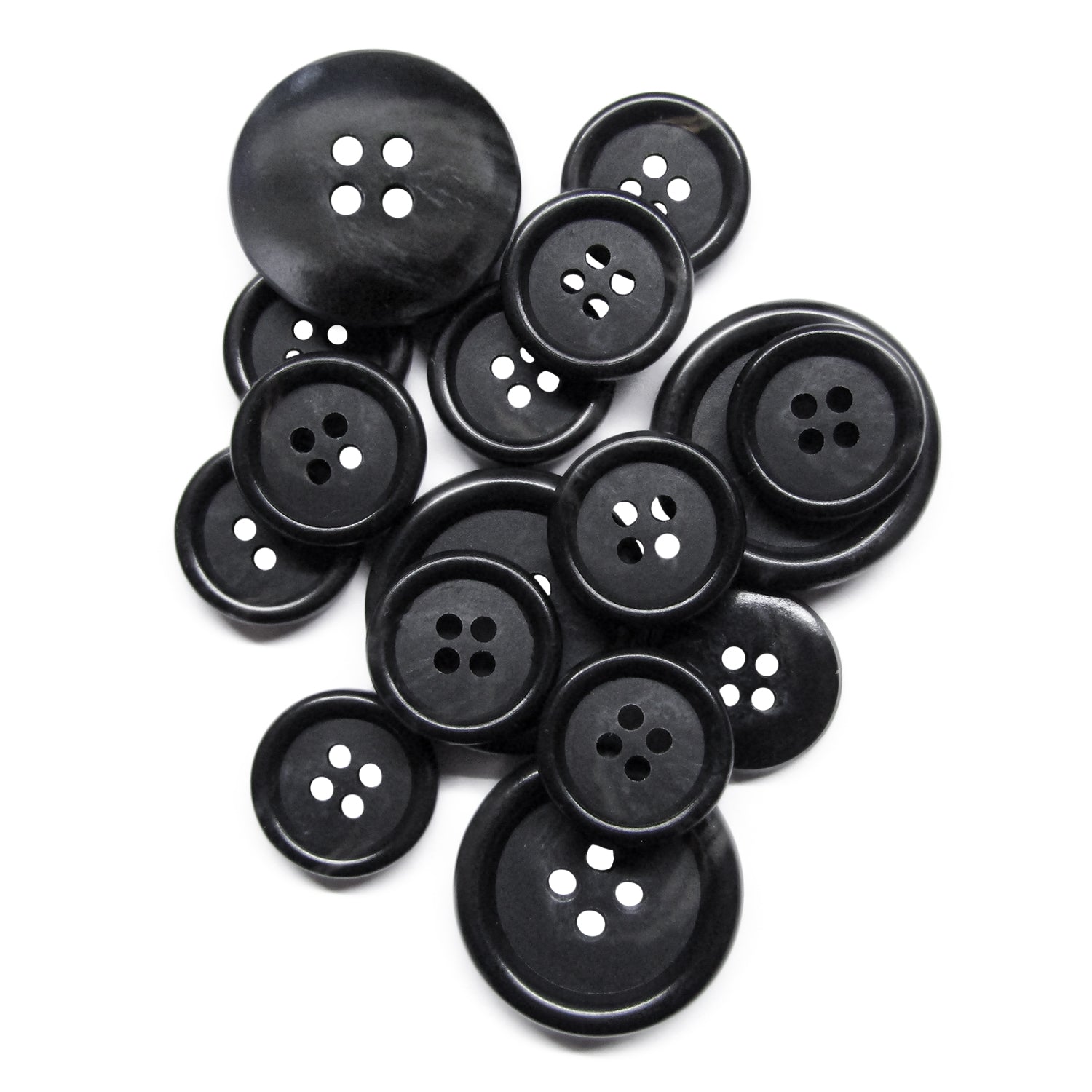 A pile of Vegan Faux Horn Suit Buttons, black with four holes and in various sizes, displayed on a white background.