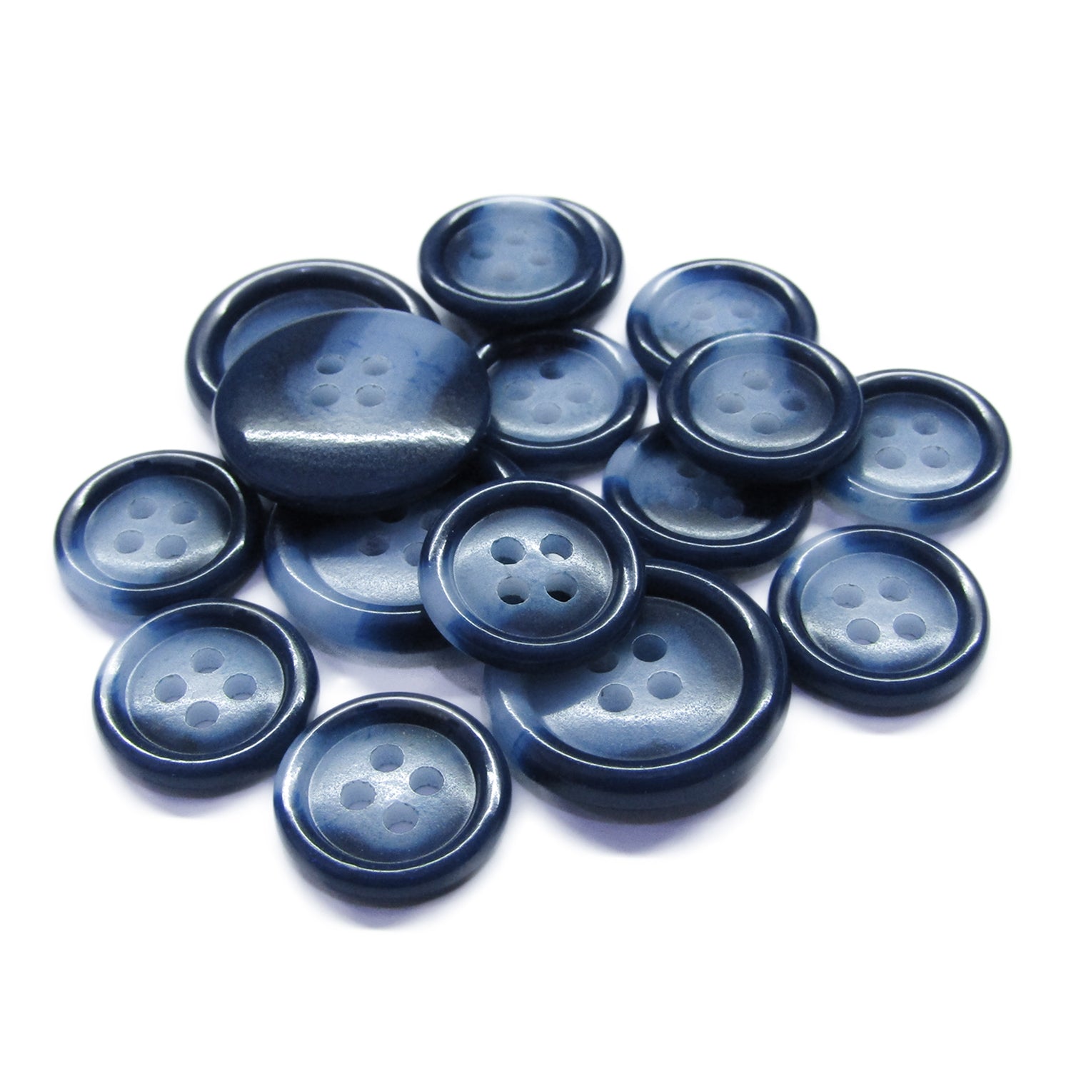 A pile of Luxury Suit Buttons, dark blue with four holes and made of vegan plastic, sits on a white background.
