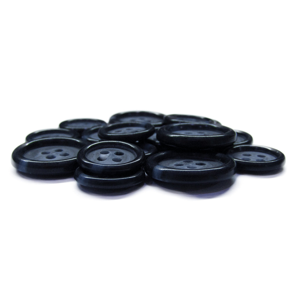 Luxury Suit Buttons in black with four holes are stylishly arranged on a white surface.
