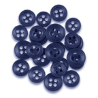 A pile of dark blue, matte finish Replacement Shirt Buttons with four holes is scattered on a white background—ideal for any tailor's kit.