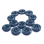 Twelve Work Shirt Buttons from a 12 Pack arranged in the shape of a question mark on a white background.