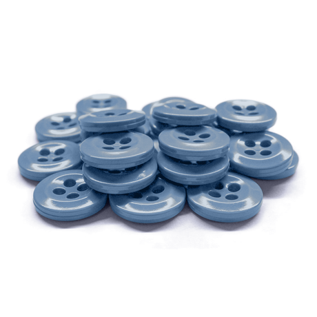 A pile of Work Shirt Buttons—shiny, light blue, four-holed—lies on a white background.