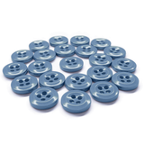 Twenty-three blue Work Shirt Buttons, each with four holes, are arranged in a pattern on a white background.