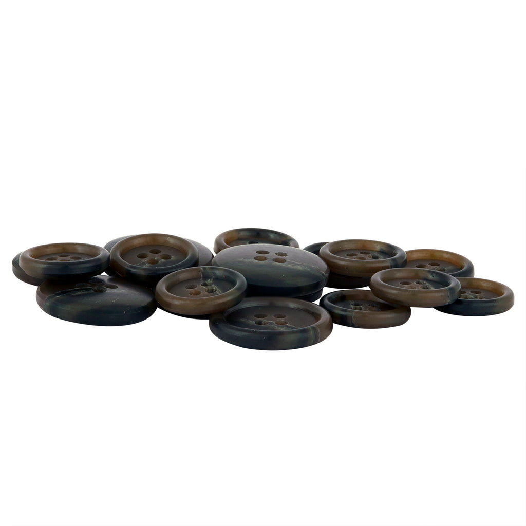 A pile of Vegan Faux Horn Suit Buttons, round in brown and black with four holes, rests on a white background—ideal for ethical sewing projects.