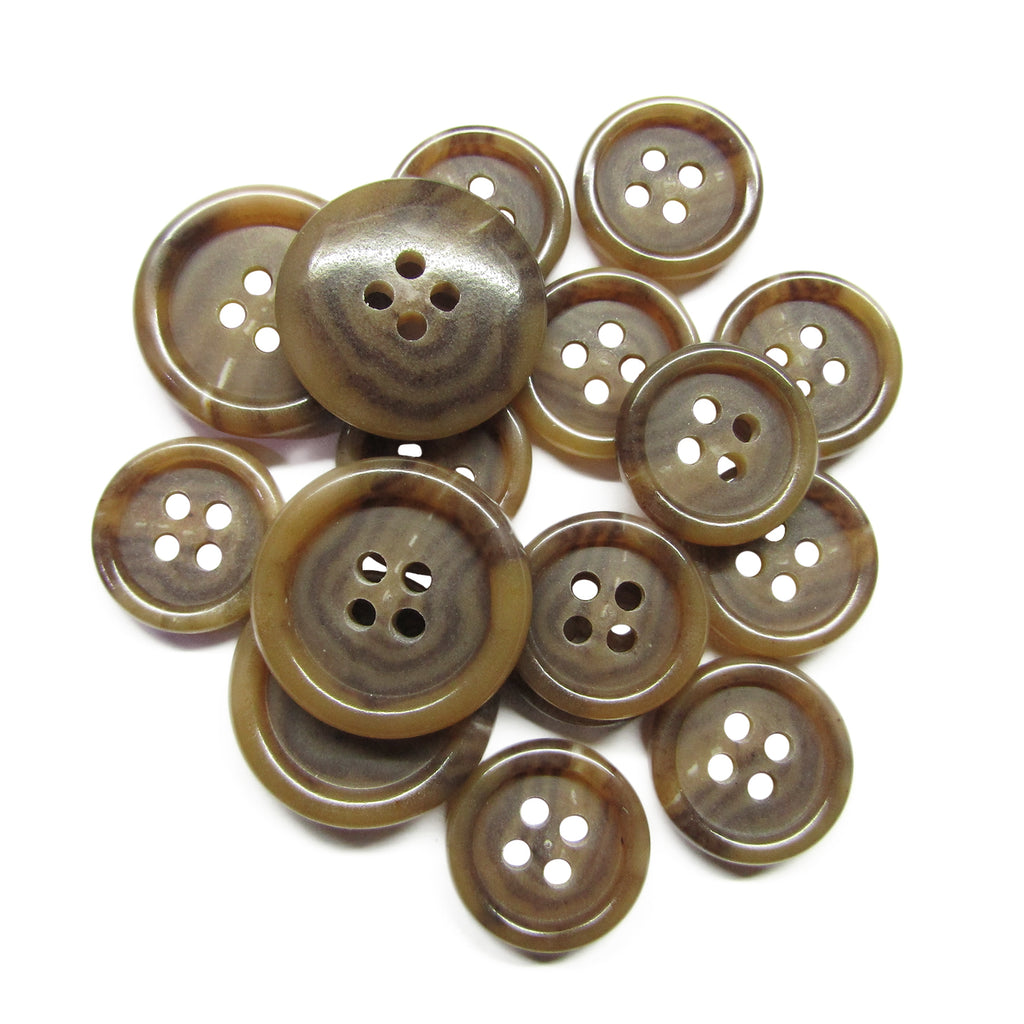 A pile of Luxury Suit Buttons in brown, marbled vegan material and various sizes, resembling classic four-hole suit buttons, arranged on a white background.