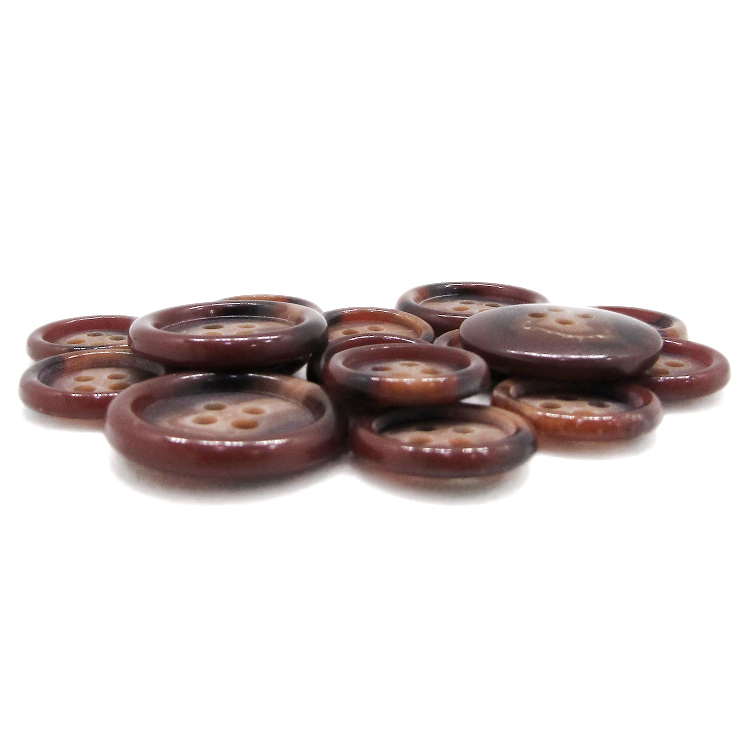 A pile of Luxury Suit Buttons, featuring assorted brown round four-hole styles, is spread on a white surface.
