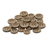 A pile of brown Replacement Shirt Buttons made of poly-nylon with an anti-glare matte finish is scattered on a white background.