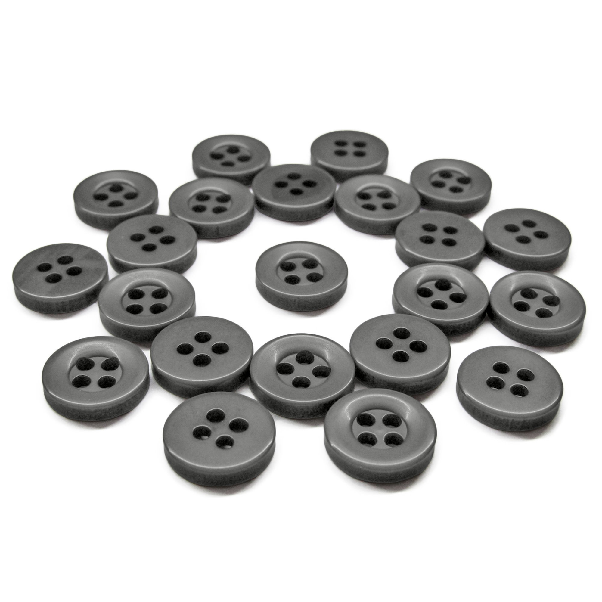 A set of Workshop Uniform Shirt Buttons, black with four holes, displayed in a loose, scattered arrangement on a white background.