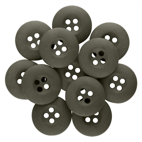 A pile of round, black Tactical Buttons with four holes overlaps each other on a white background.