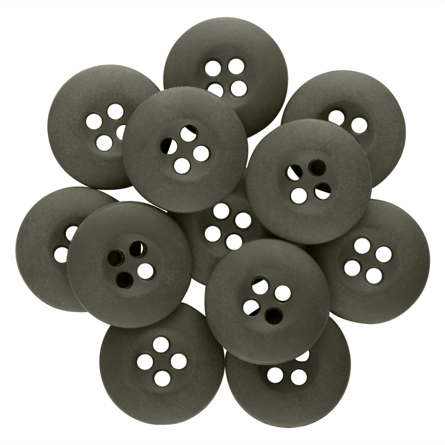 A pile of round, black Tactical Buttons with four holes overlaps each other on a white background.
