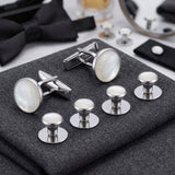 Tuxedo Shirt Studs and Cufflinks featuring elegant white mother-of-pearl inlays, ideal tuxedo shirt accessories, displayed on folded gray fabric.