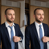 A man in a navy suit adjusts his tie in a bedroom, shown in two similar poses side by side, keeping his shirt collar crisp and sharp with the help of discreet Collar Stays.