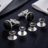 The Tuxedo Shirt Studs and Cufflinks, featuring sleek silver with black centers, add an elegant touch to a white dress shirt and navy suit.