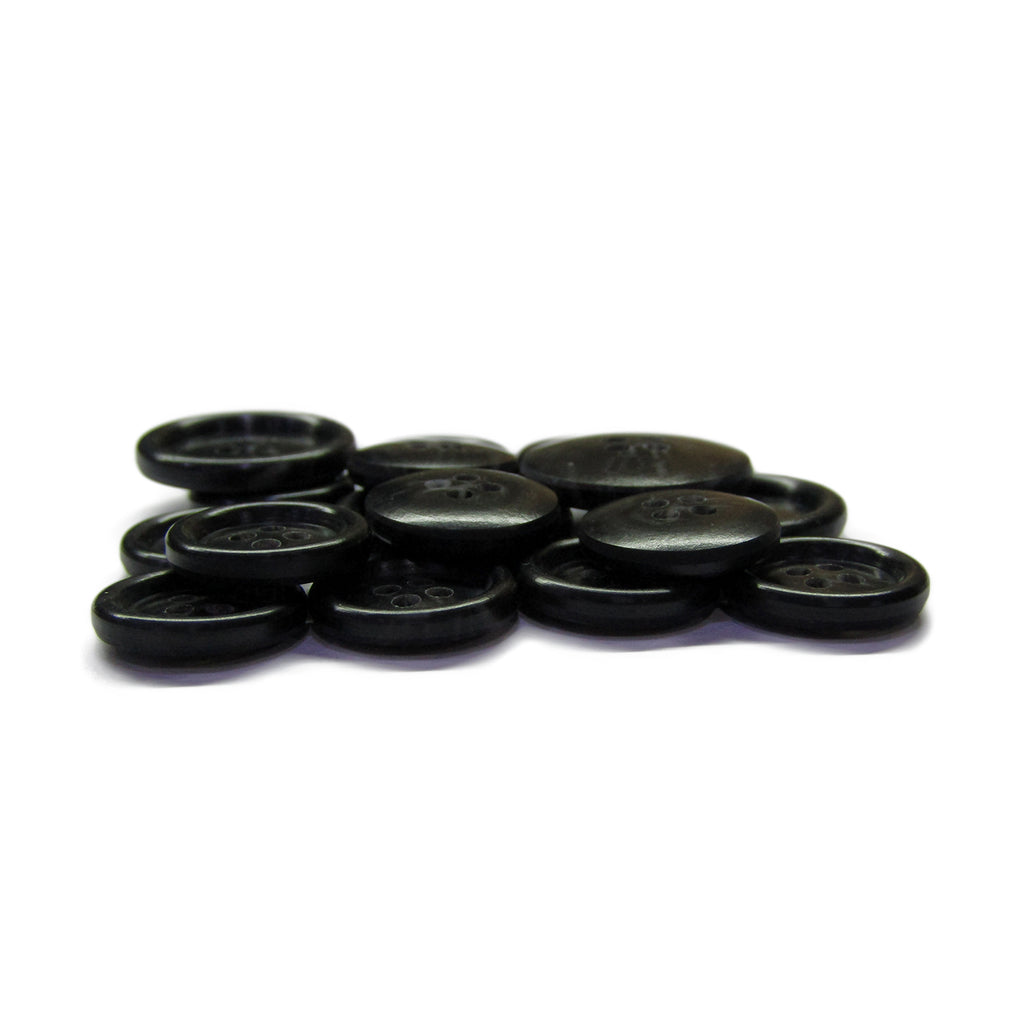A stack of Premium Suit Buttons, black with four holes each, shown together on a white background.
