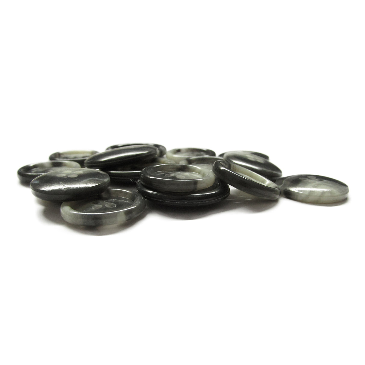 A pile of Premium Suit Buttons, round and flat in black and gray, scattered on a white surface.
