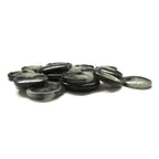 A pile of Premium Suit Buttons, round and flat in black and gray, scattered on a white surface.