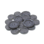 A pile of round, gray Luxury Suit Buttons with four holes, arranged on a white background.