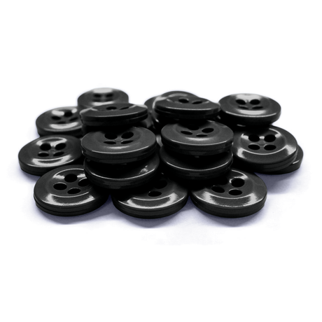 Work Shirt Buttons in black are scattered and stacked on a white surface.