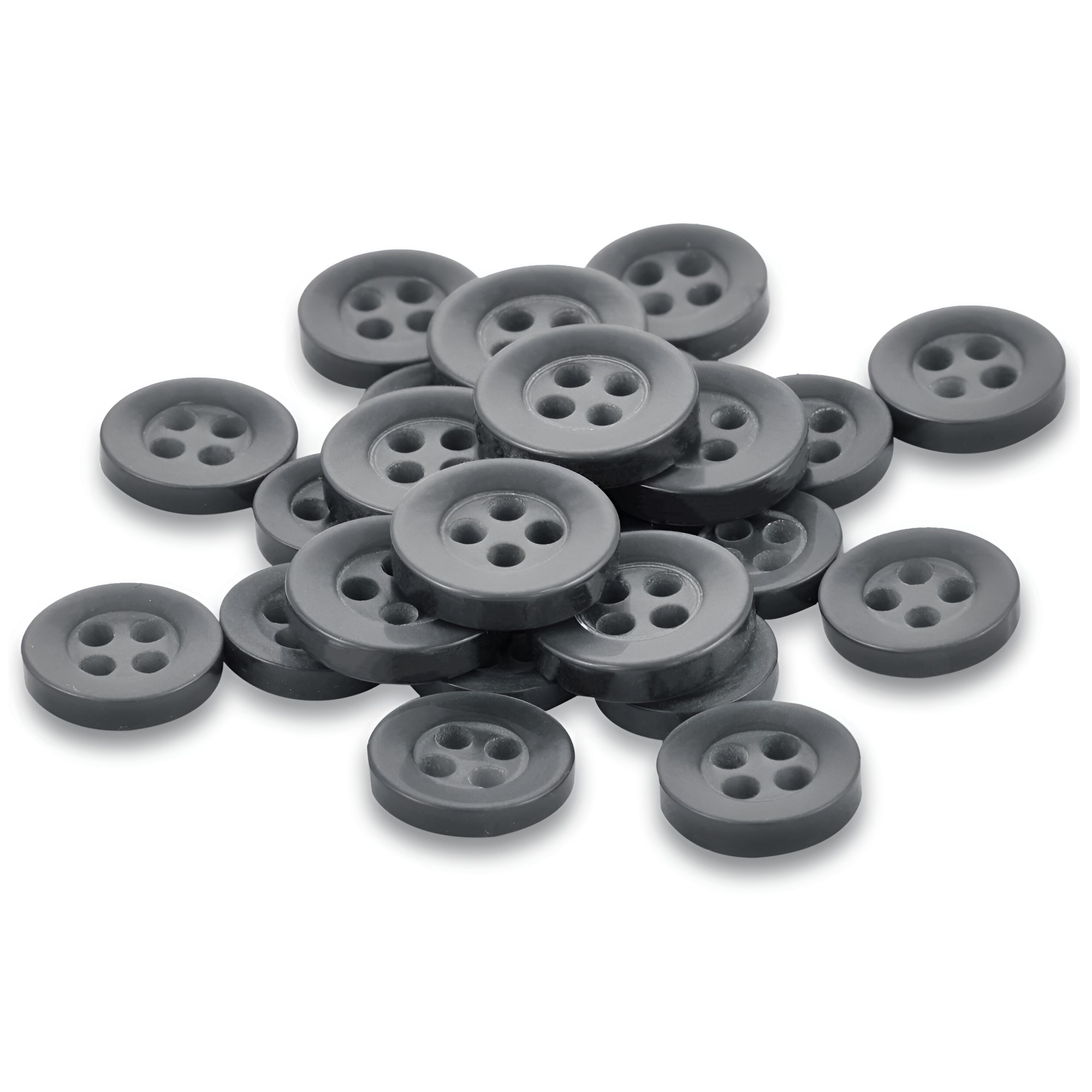 A pile of Replacement Shirt Buttons—small, round, black Poly-Nylon with four holes—is scattered on a white surface, ideal durable options for any tailor's kit.