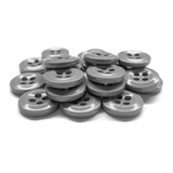 A stack of gray Work Shirt Buttons, each with four holes, arranged on a white surface.
