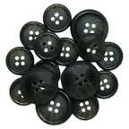 A collection of Luxury Suit Buttons—black, round, four-hole vegan buttons in assorted sizes—displayed on a white background.