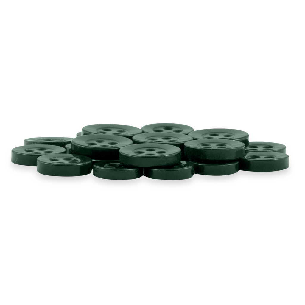 A pile of Replacement Shirt Buttons in dark green, round, four-hole poly-nylon, displayed on a white background—an ideal addition to any tailor's kit.