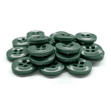 A stack of green Work Shirt Buttons arranged on a white surface.