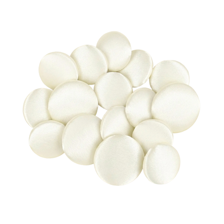 A pile of Tuxedo Suit Buttons made from round, smooth, white satin fabric rests on a white background.