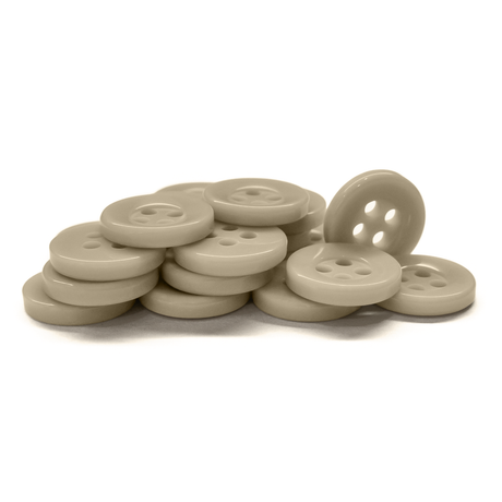 A collection of Workshop Uniform Shirt Buttons in beige, with four holes, stacked and scattered on a white background.