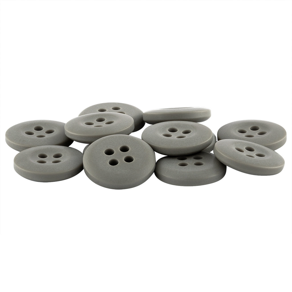 A pile of round, flat Khakis, Chinos and Casual Cotton Pant Buttons in gray nylon with four holes each, overlapping on a white background.
