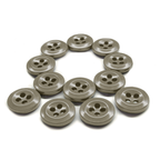 Twelve Work Shirt Buttons 12 Pack arranged in the shape of a question mark on a white background.
