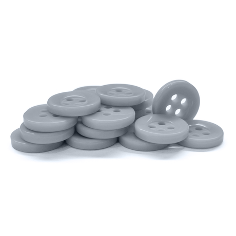 A stack of gray, four-hole Workshop Uniform Shirt Buttons made of durable nylon rests on a white surface.
