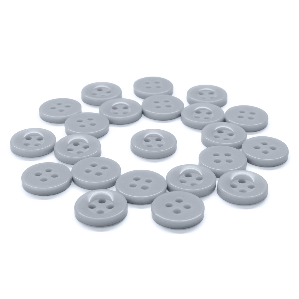 A set of Workshop Uniform Shirt Buttons, gray and round with four holes, arranged loosely on a white background.