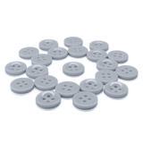 A set of Workshop Uniform Shirt Buttons, gray and round with four holes, arranged loosely on a white background.