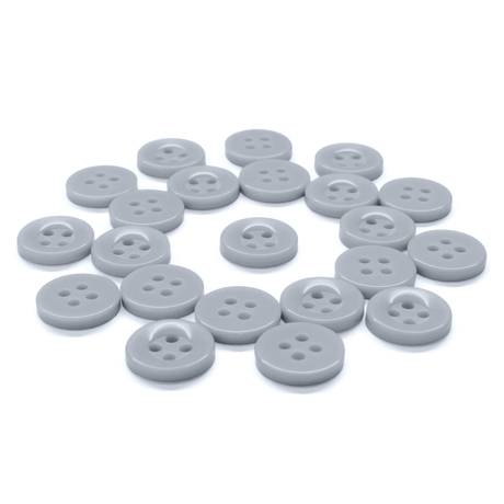 A set of Workshop Uniform Shirt Buttons, gray and round with four holes, arranged loosely on a white background.